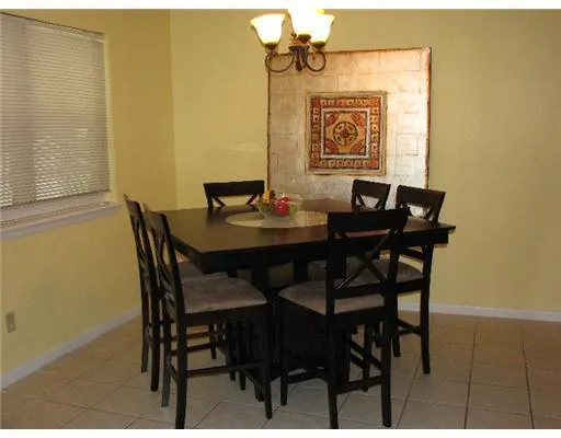 a view of a dining room with furniture and window