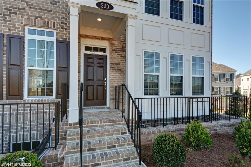 a view of a brick house with a small porch