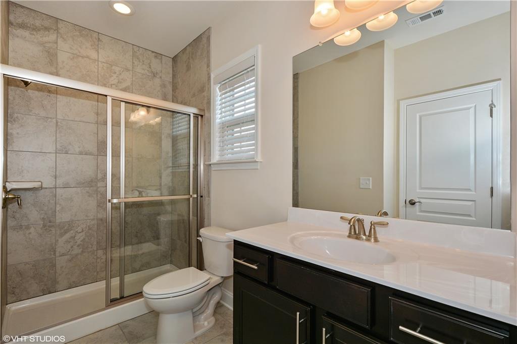 200 Braeden Way Alpharetta, GA 30009 - Photo 15 of 52 a bathroom with a double vanity sink toilet and shower