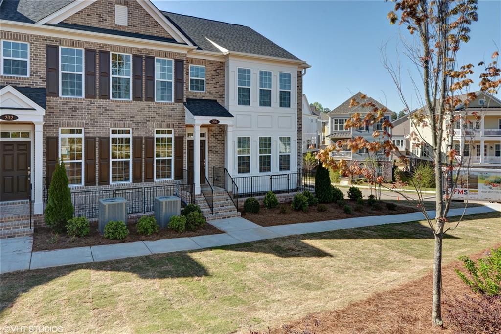 200 Braeden Way Alpharetta, GA 30009 - Photo 2 of 52 a front view of a house with a yard