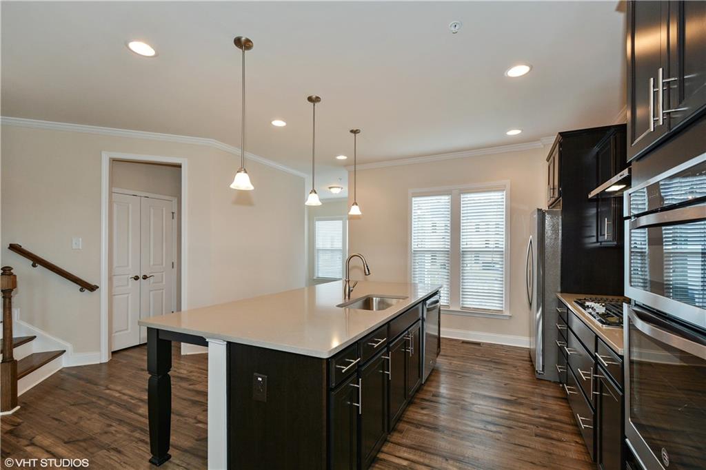 200 Braeden Way Alpharetta, GA 30009 - Photo 8 of 52 a kitchen with granite countertop a sink appliances and cabinets