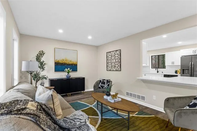a dining room with furniture window and wooden floor
