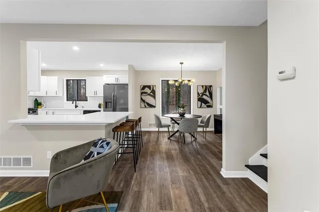 a view of a dining room with furniture and a chandelier