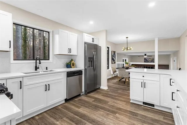 a kitchen with white cabinets and stainless steel appliances