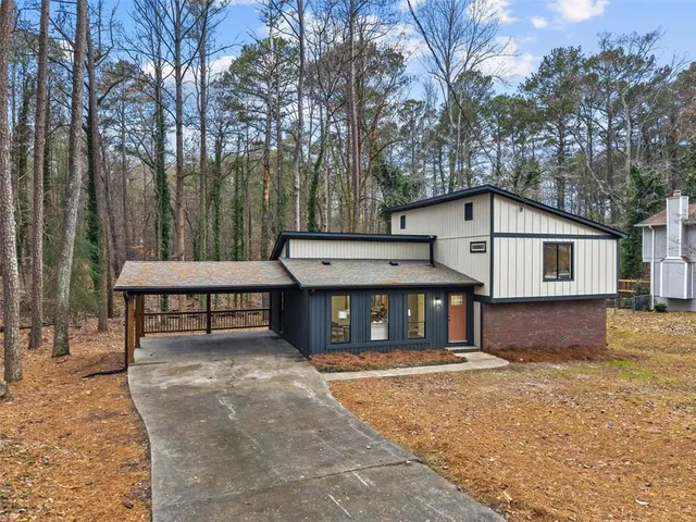a front view of a house with a yard garage and outdoor seating