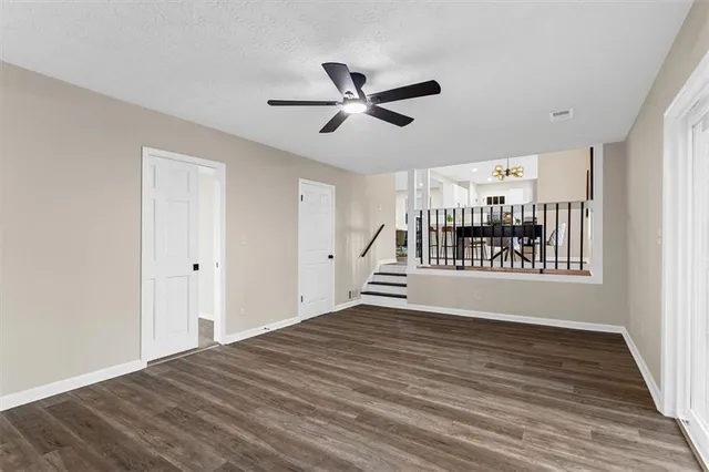 a white toilet sitting next to a white sink and vanity