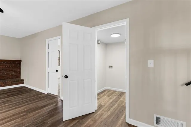 a view of a room with stairs and wooden floor