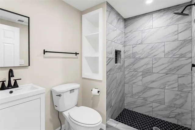 a bedroom that has a bed and a chandelier