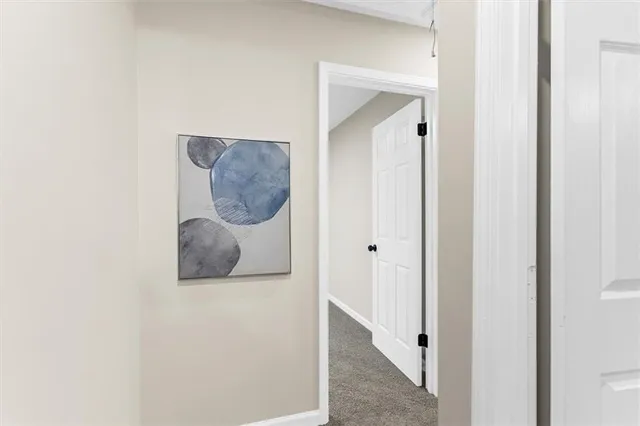 a view of a house with a wooden deck and a trees