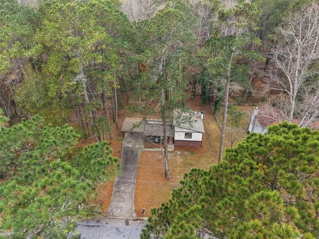 a wooden house with trees in front of it