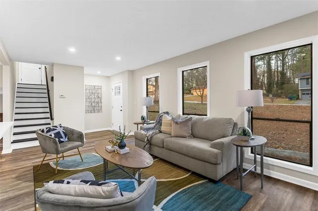 a living room with furniture and wooden floor