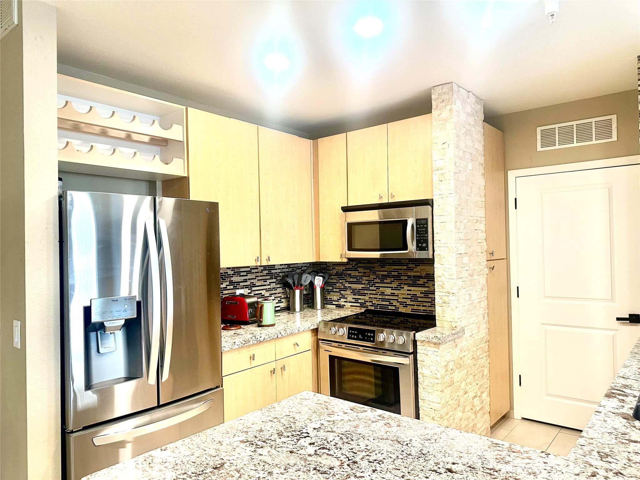 3505 Sage Road, Unit 406 Houston, TX 77056 - Photo 7 of 23 a kitchen with stainless steel appliances granite countertop a refrigerator stove and sink