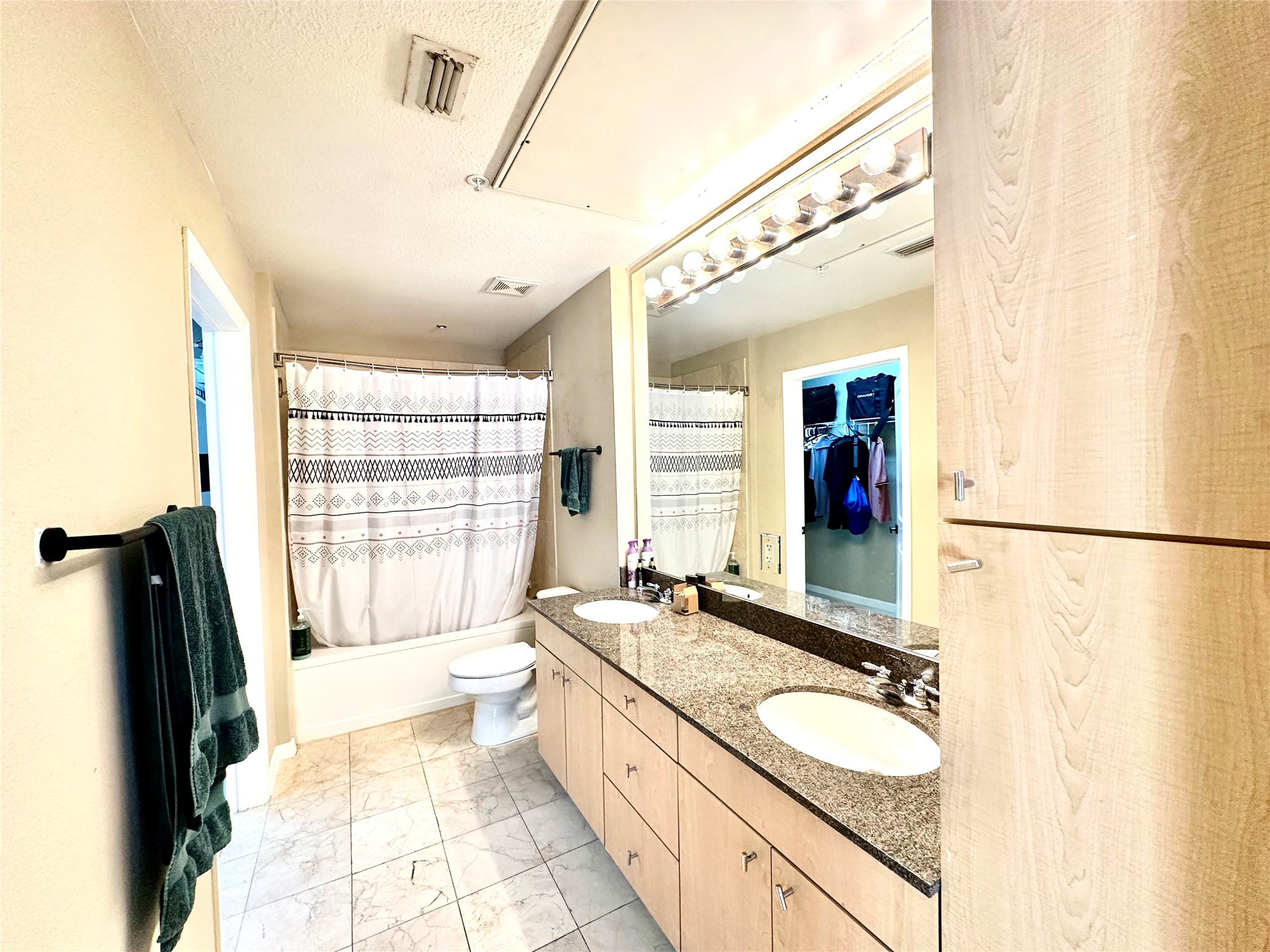 3505 Sage Road, Unit 406 Houston, TX 77056 - Photo 10 of 23 a spacious bathroom with a granite countertop sink mirror and a bathtub