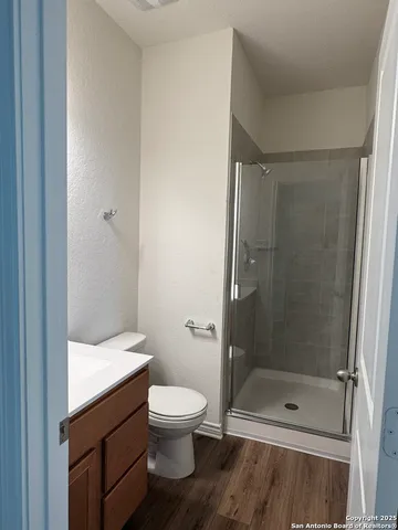 a bathroom with a shower and a toilet