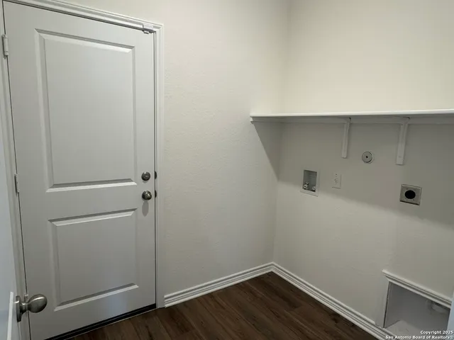 a room with linen closet and wooden floor