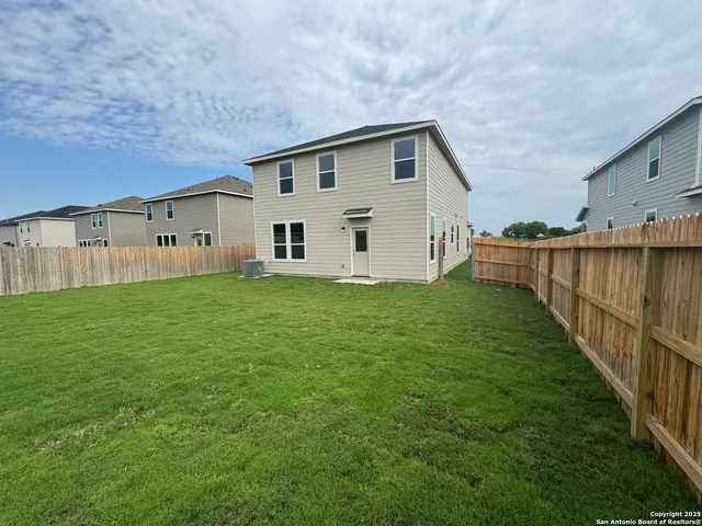 a view of a house with backyard and garden