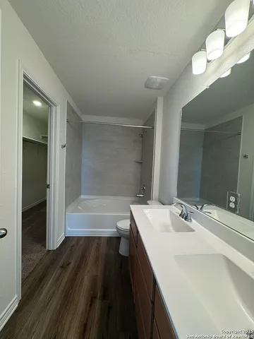 a bathroom with a sink a large mirror and a bathtub