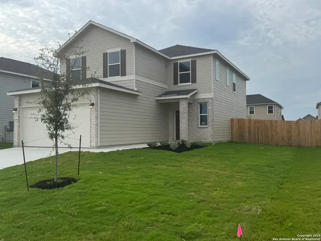 a view of a backyard of the house