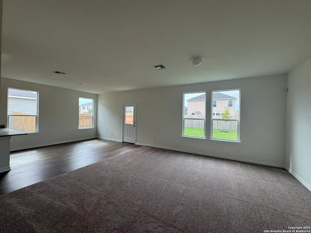 an empty room with windows and closet in it