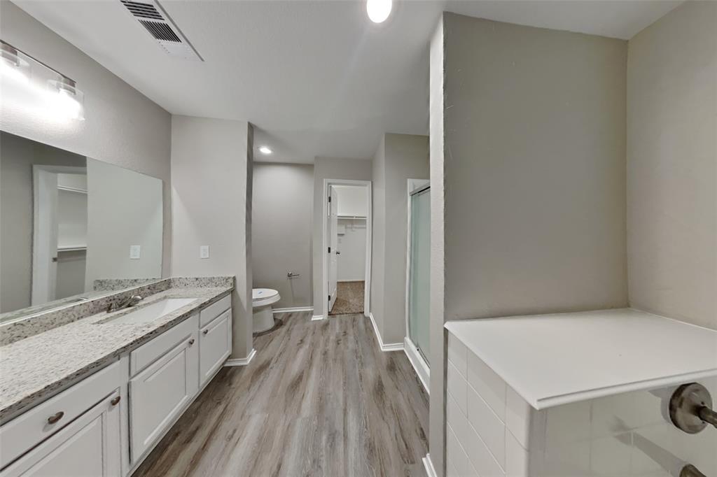 817 Fox Hunt Trail Fort Worth, TX 76179 - Photo 9 of 17 Full bath featuring vanity, recessed lighting, a walk in closet, a shower stall, and light wood finished floors