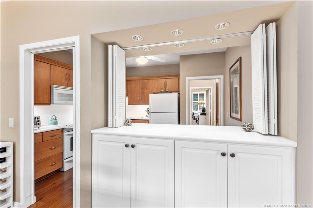 13424 Harbour Ridge Boulevard, Unit 4A Palm City, FL 34990 - Photo 11 of 33 a en suite bathroom with a sink a mirror and a shower