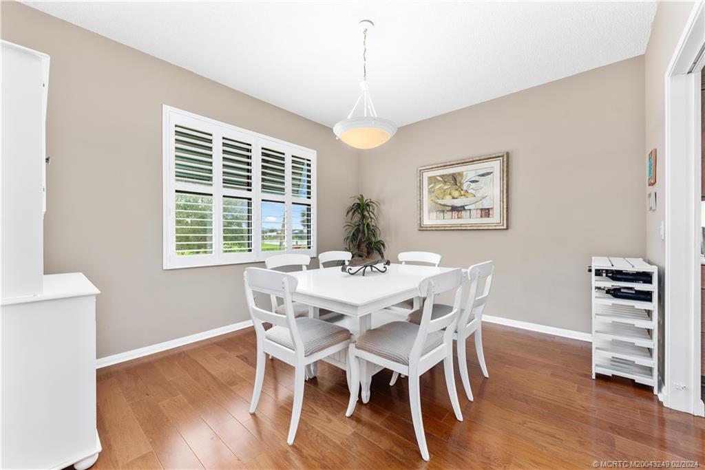 13424 Harbour Ridge Boulevard, Unit 4A Palm City, FL 34990 - Photo 12 of 33 a view of a dining room with furniture window and wooden floor