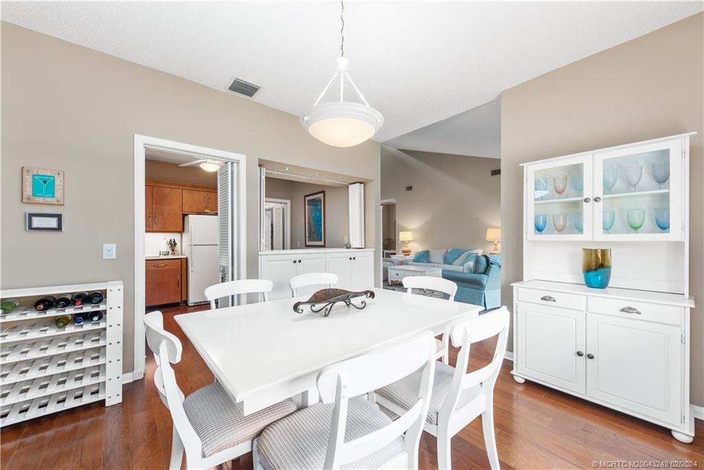 13424 Harbour Ridge Boulevard, Unit 4A Palm City, FL 34990 - Photo 13 of 33 a view of a dining room with furniture and wooden floor