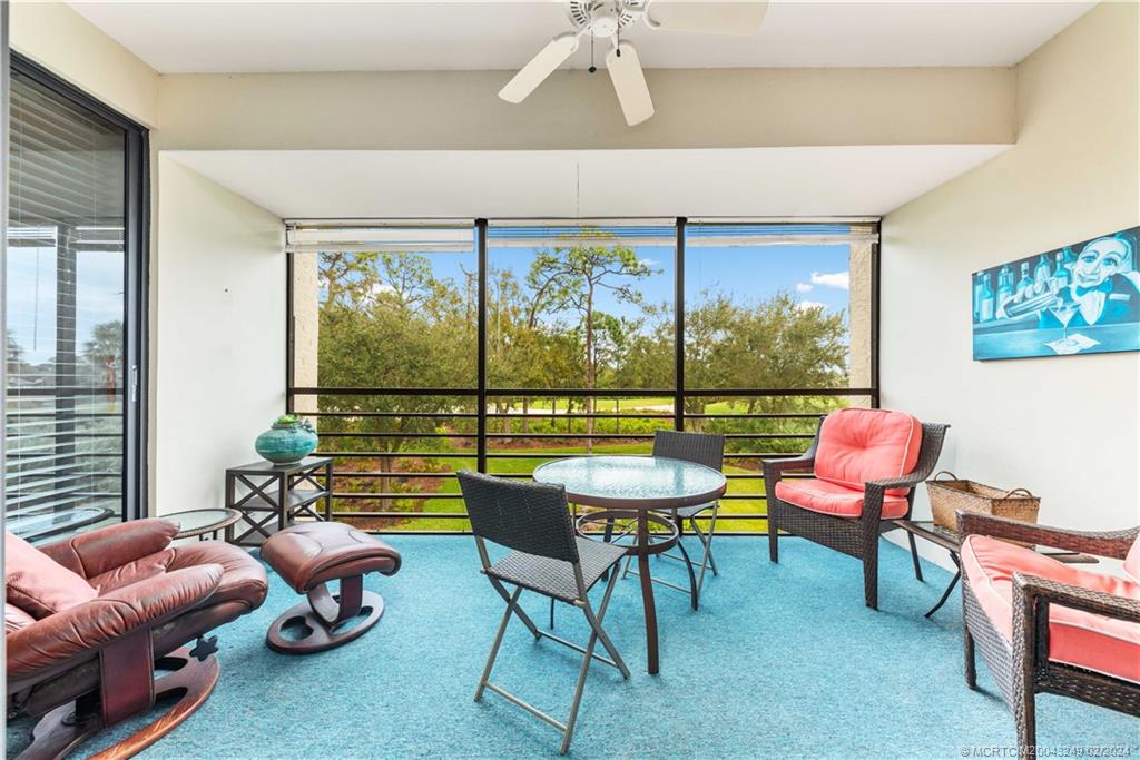 13424 Harbour Ridge Boulevard, Unit 4A Palm City, FL 34990 - Photo 14 of 33 a living room with furniture and a floor to ceiling window