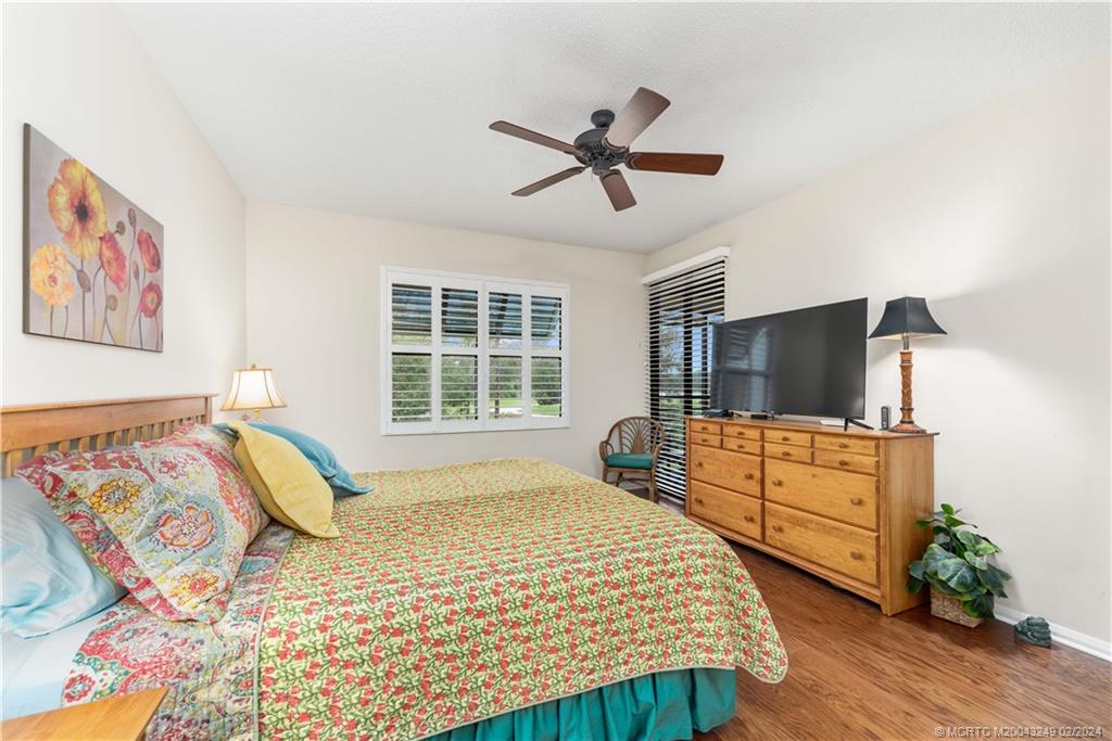 13424 Harbour Ridge Boulevard, Unit 4A Palm City, FL 34990 - Photo 17 of 33 a bedroom with a bed and a flat screen tv