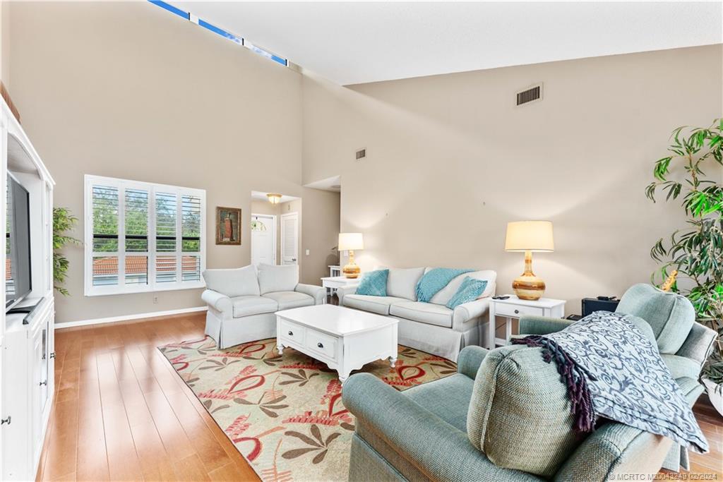 13424 Harbour Ridge Boulevard, Unit 4A Palm City, FL 34990 - Photo 7 of 33 a living room with furniture and a large window