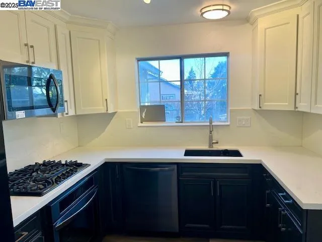 a kitchen with a sink and cabinets