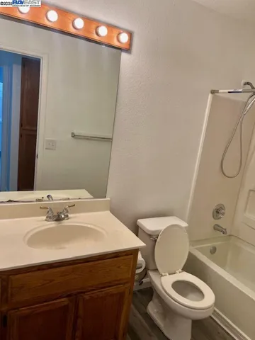 a bathroom with a sink mirror toilet and shower