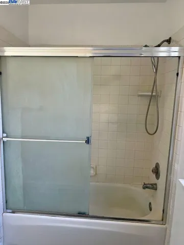 a bathroom with a shower and a shower