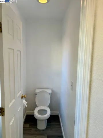a white toilet sitting next to a shower curtain