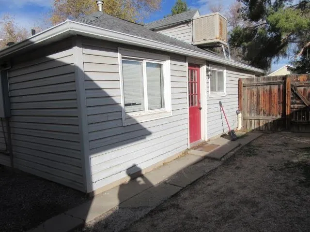 a backyard of a house with wooden fence
