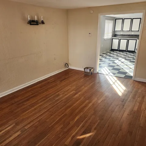 a view of a room with wooden floor and chair