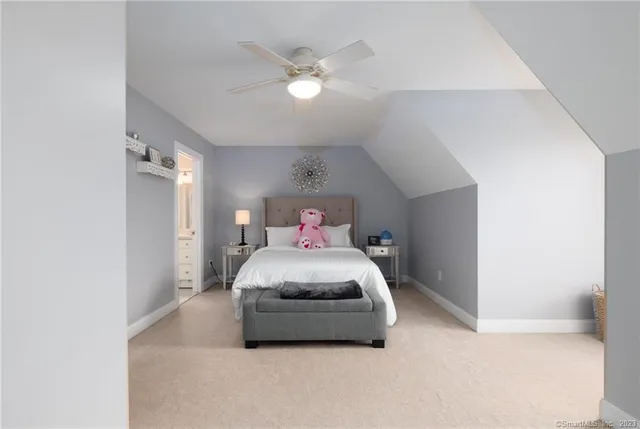 a bedroom with a bed and a ceiling fan