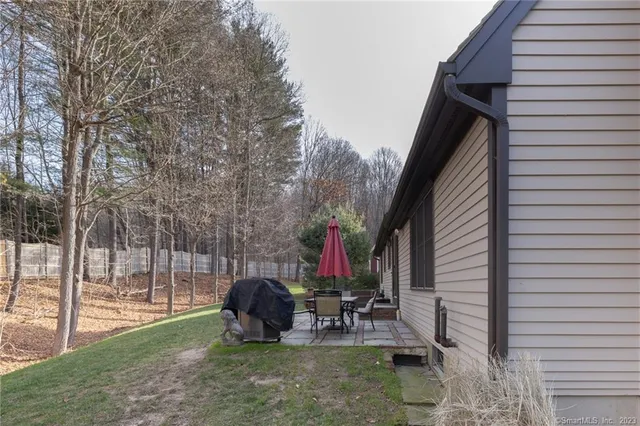 a view of a patio with a table chairs and a backyard