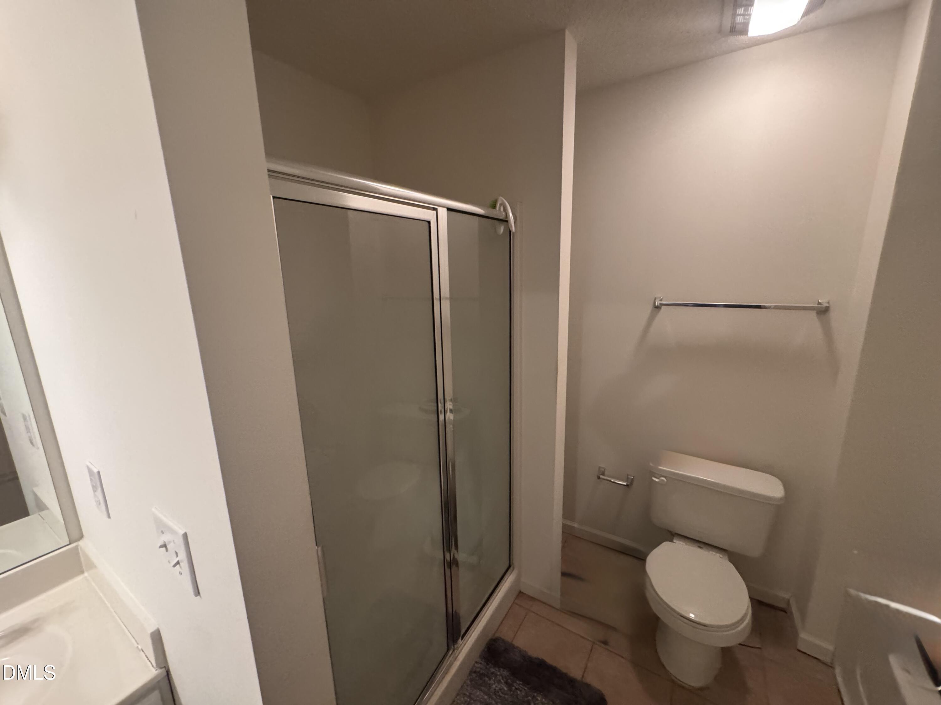 11221 Avocet Lane, Unit 102 Raleigh, NC 27617 - Photo 12 of 14 a white toilet sitting next to a shower