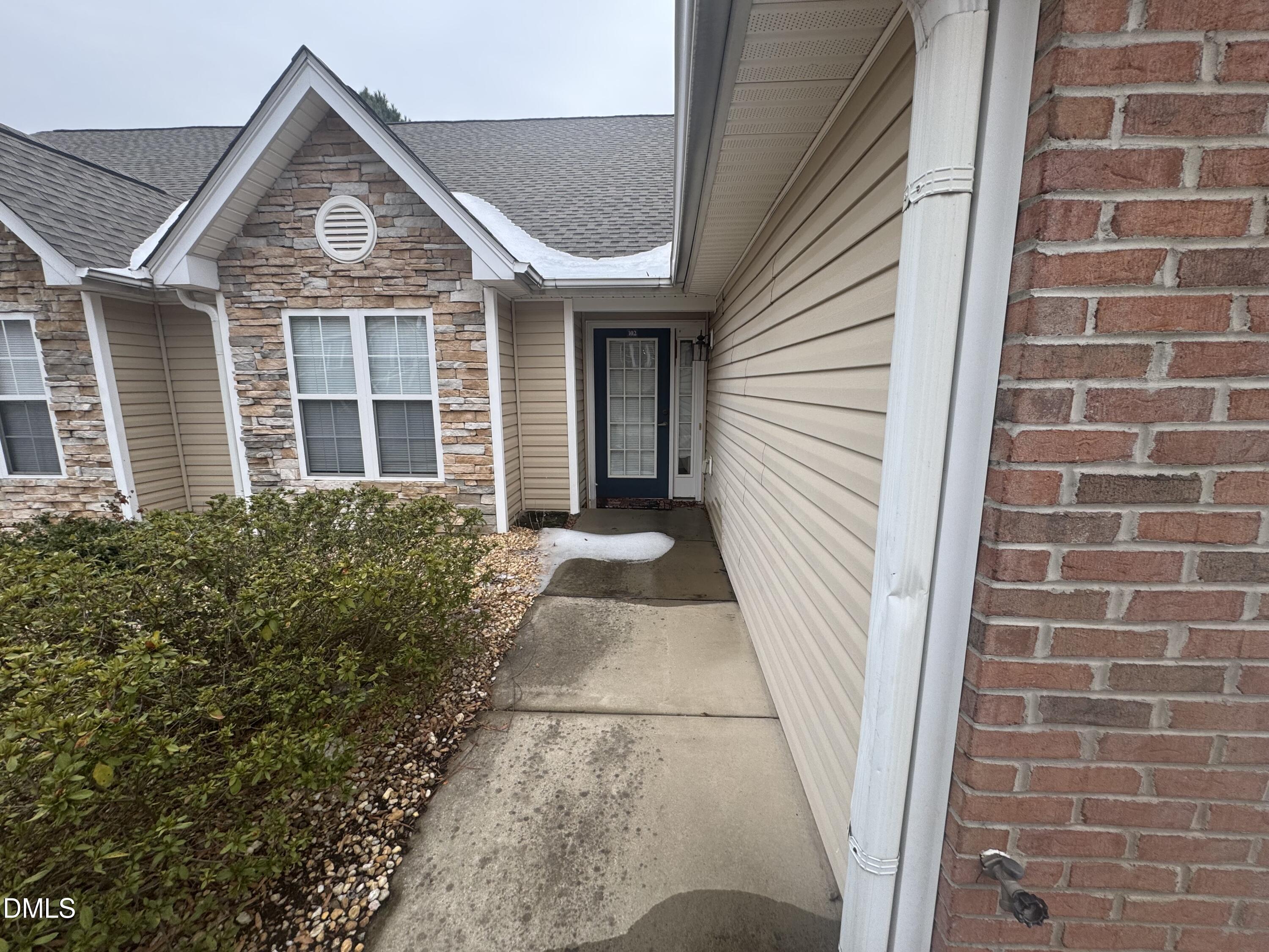 11221 Avocet Lane, Unit 102 Raleigh, NC 27617 - Photo 3 of 14 a front view of a house with a yard