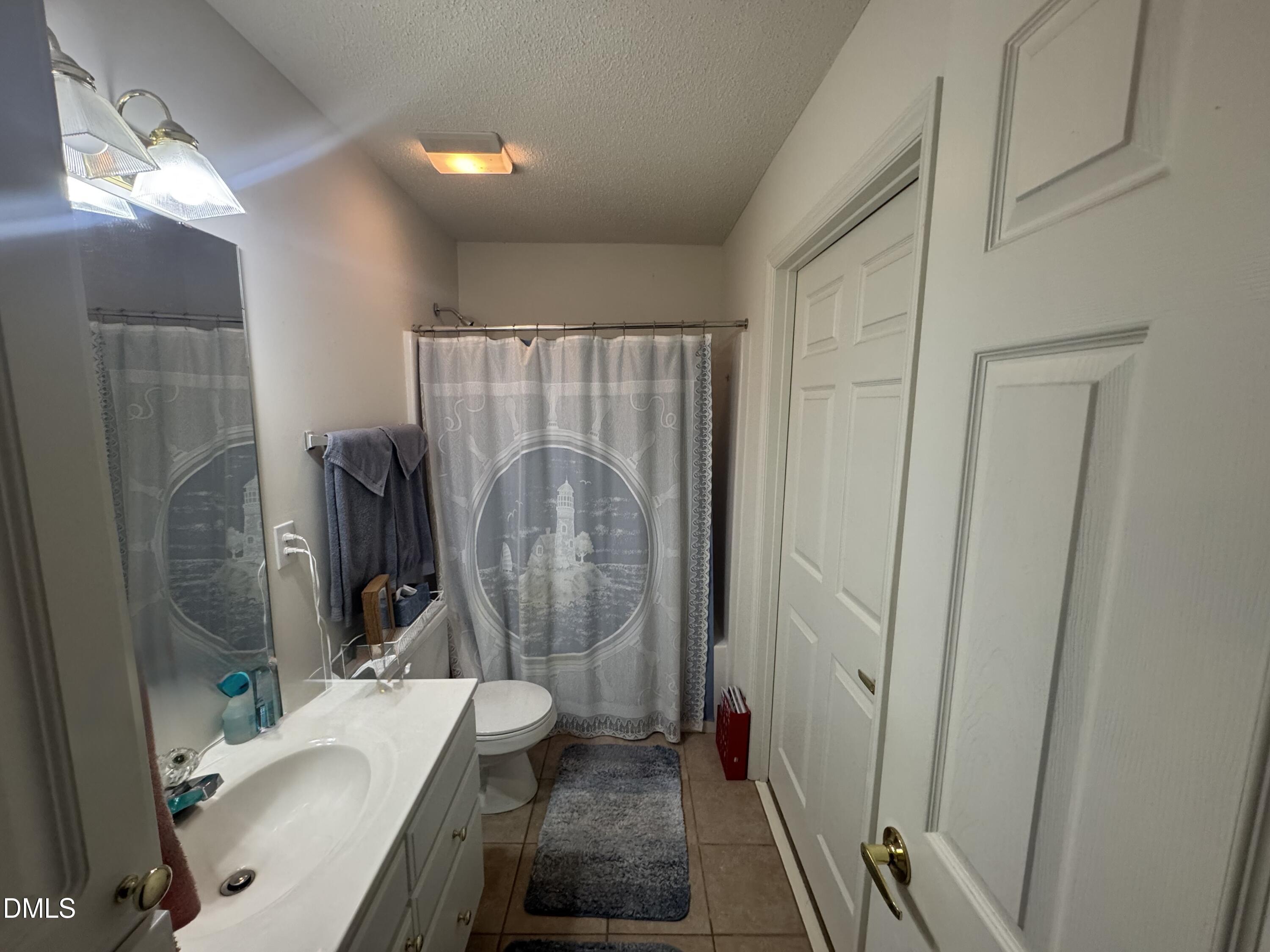 11221 Avocet Lane, Unit 102 Raleigh, NC 27617 - Photo 10 of 14 a bathroom with a sink toilet and shower