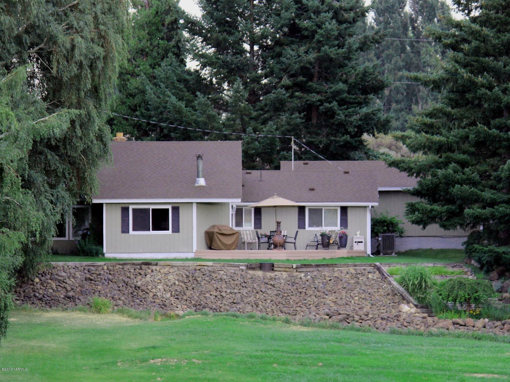 a aerial view of a house with a yard patio and green space