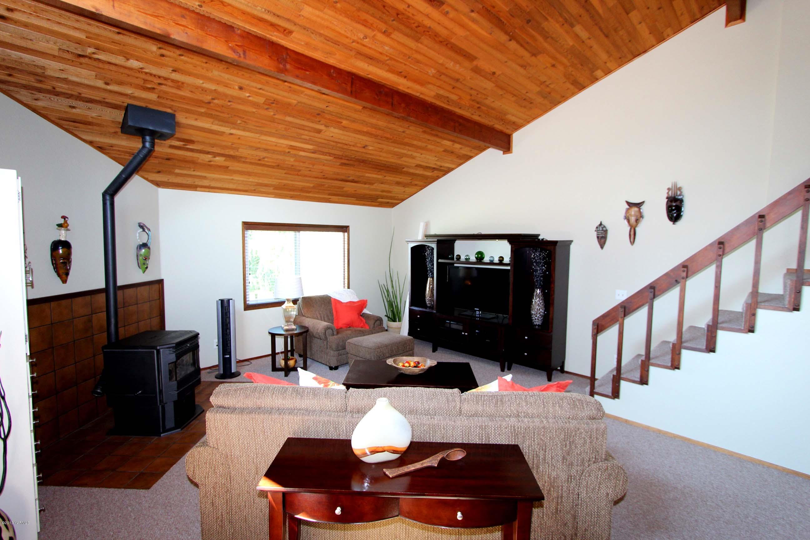 170 Wilcox Road Cowiche, WA 98923 - Photo 14 of 39 a living room with furniture a flat screen tv and a fireplace