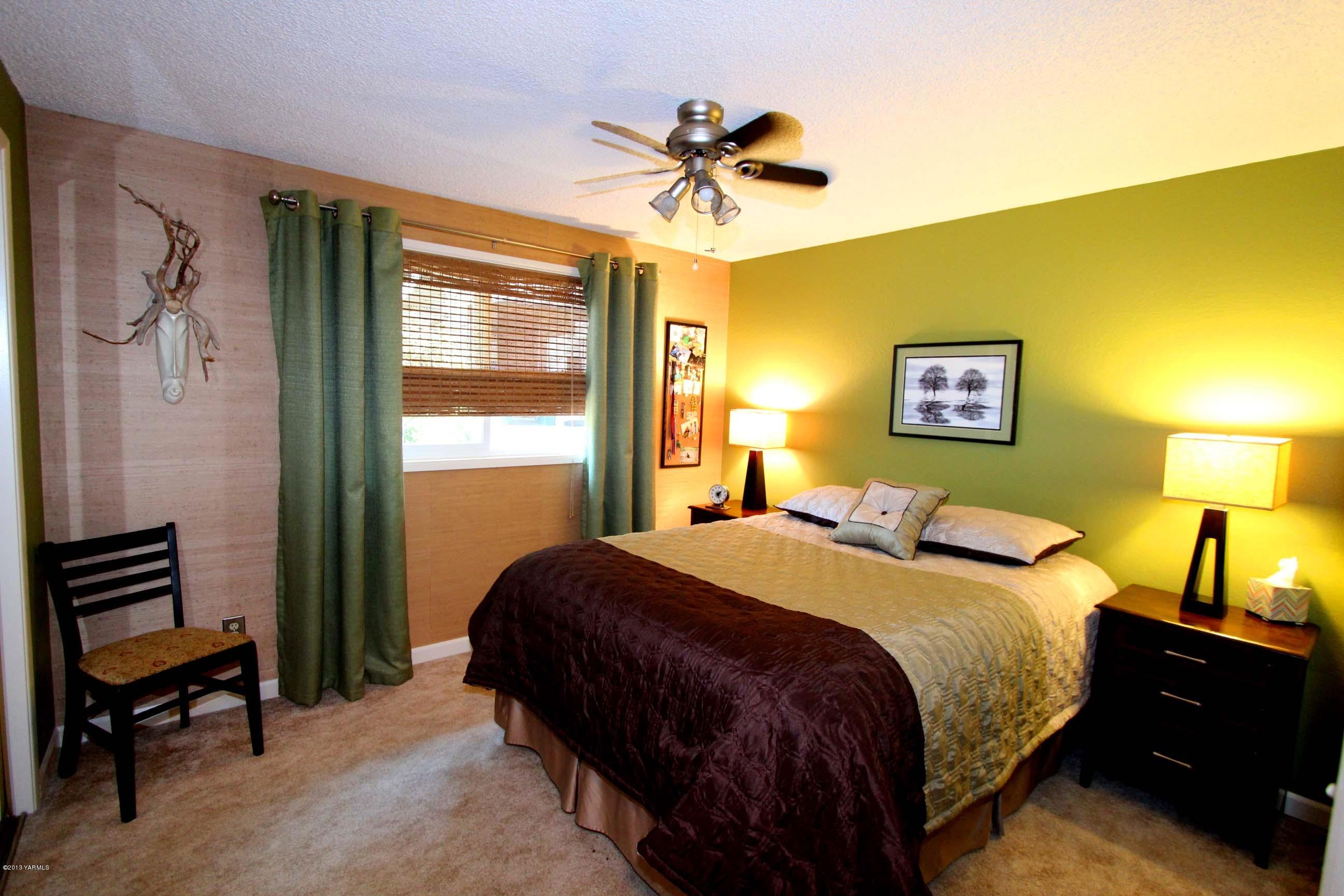 170 Wilcox Road Cowiche, WA 98923 - Photo 16 of 39 a bedroom with a bed and a chandelier