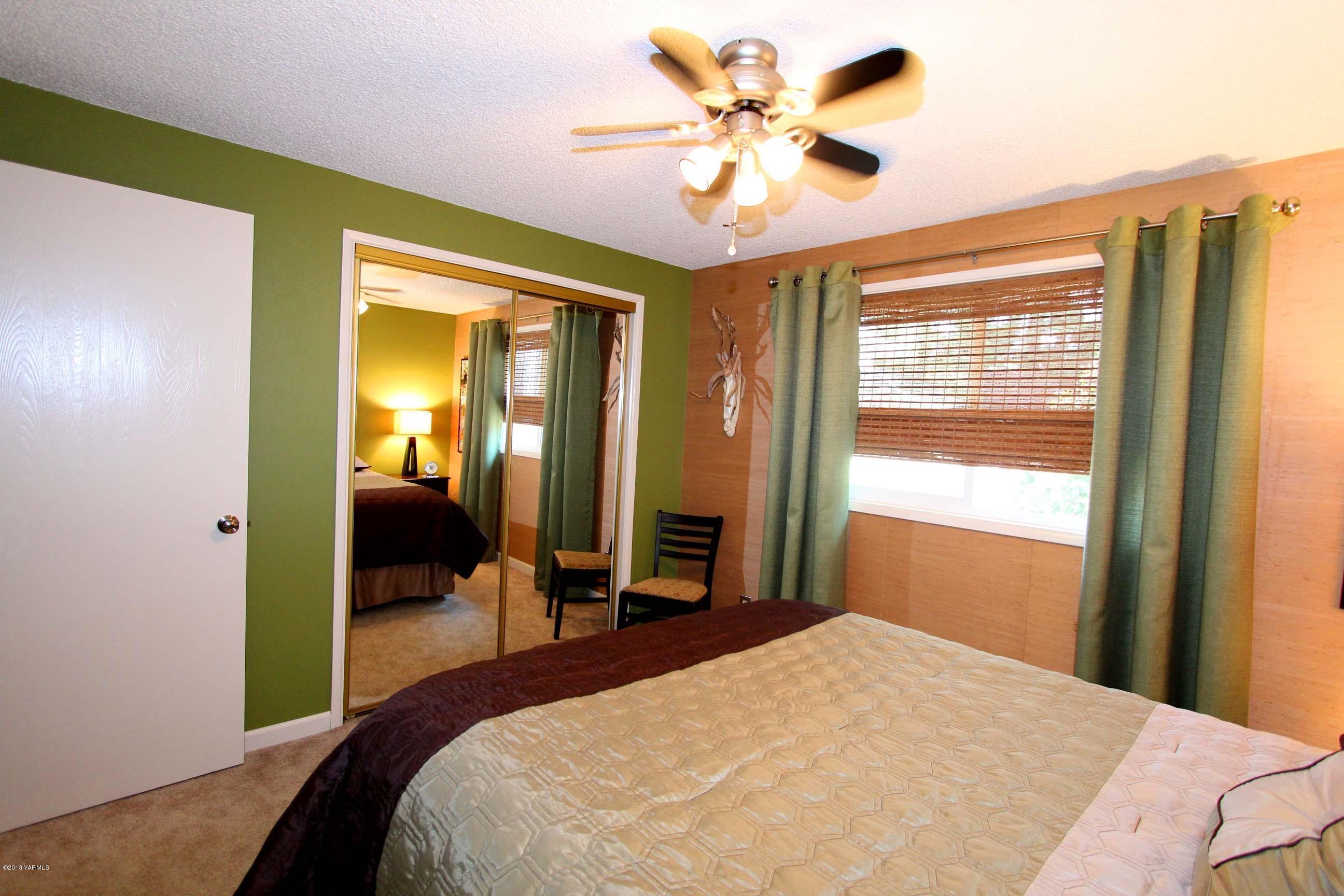 170 Wilcox Road Cowiche, WA 98923 - Photo 17 of 39 a bedroom with a bed and a chandelier