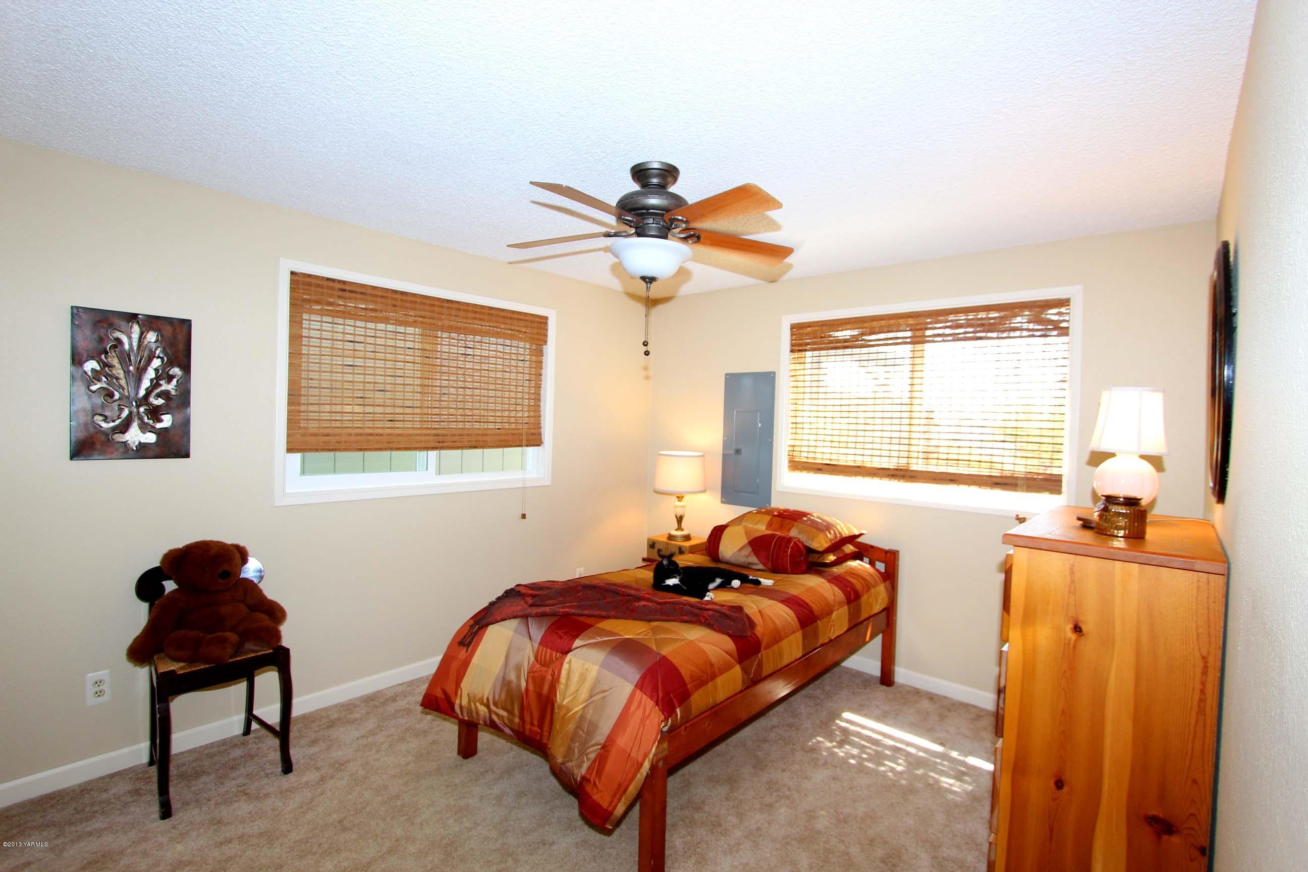 170 Wilcox Road Cowiche, WA 98923 - Photo 18 of 39 a bed room with a bed and a chandelier