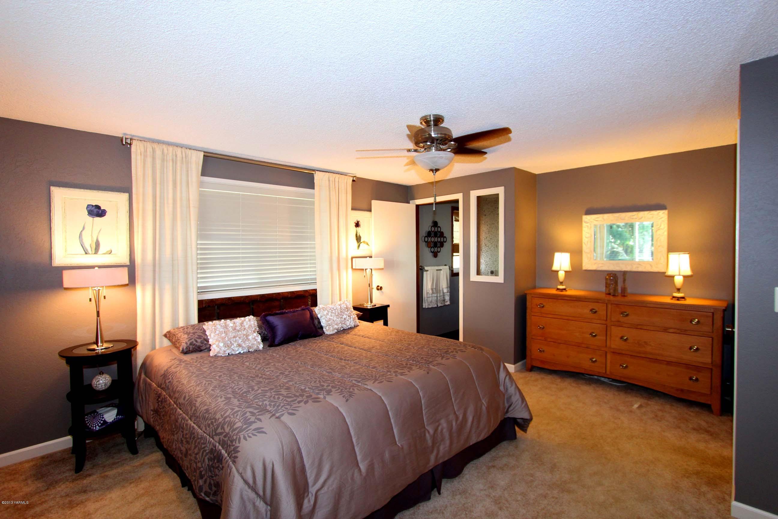 170 Wilcox Road Cowiche, WA 98923 - Photo 21 of 39 a bedroom with a bed and a chandelier