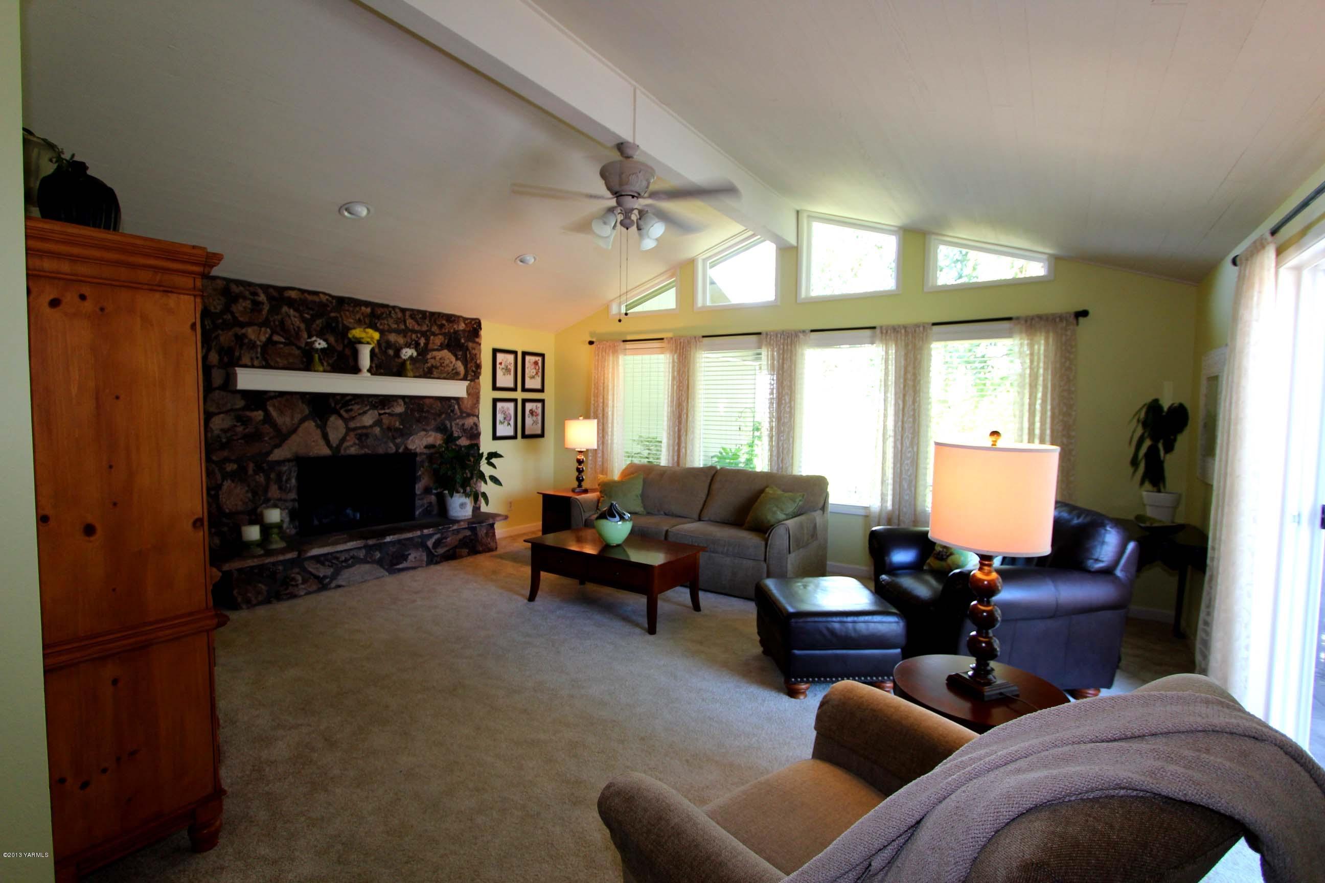 170 Wilcox Road Cowiche, WA 98923 - Photo 5 of 39 a living room with furniture a fireplace and a large window