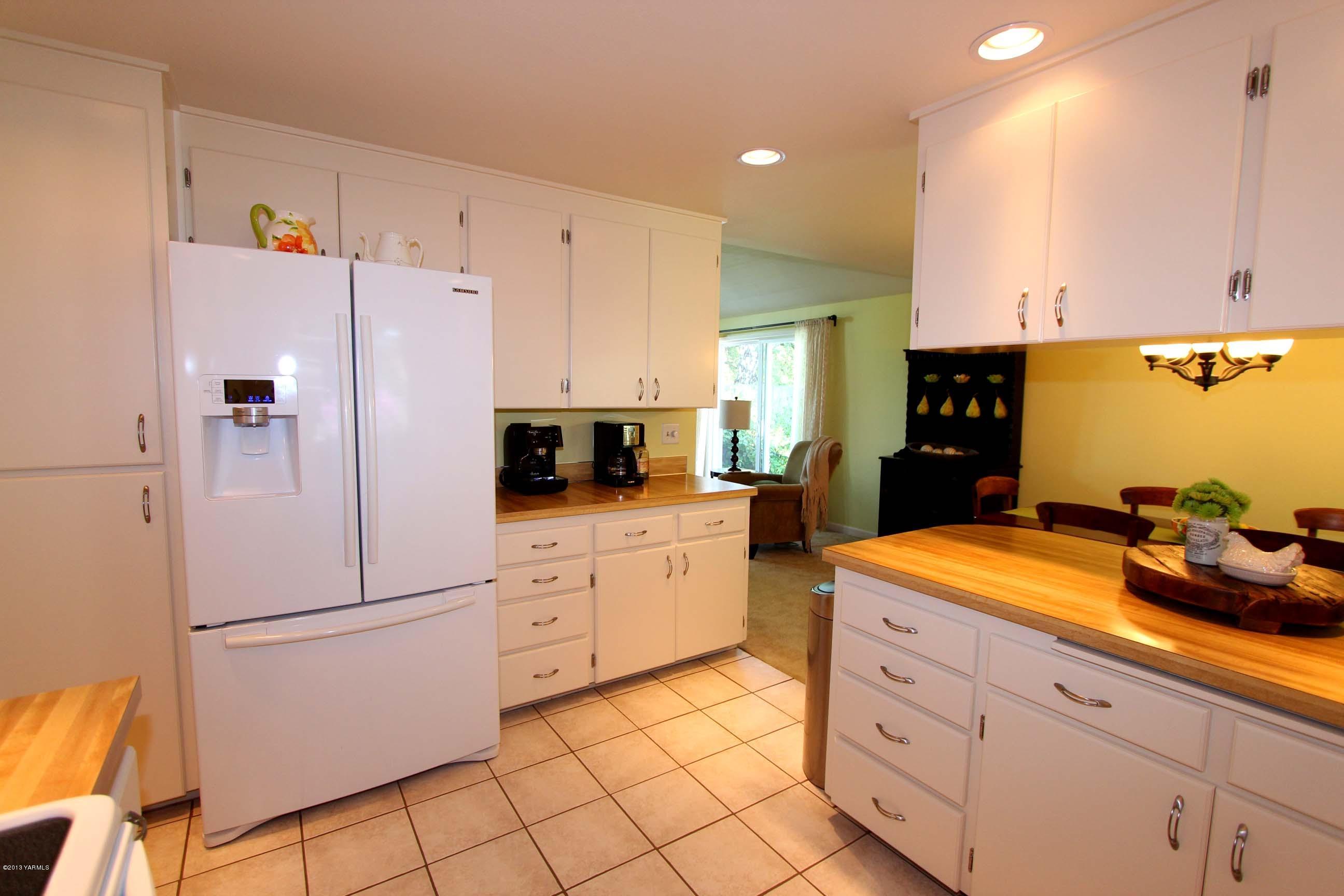170 Wilcox Road Cowiche, WA 98923 - Photo 7 of 39 a kitchen with white cabinets and white appliances