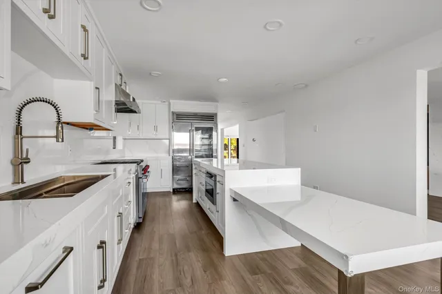 a kitchen with cabinets and wooden floor